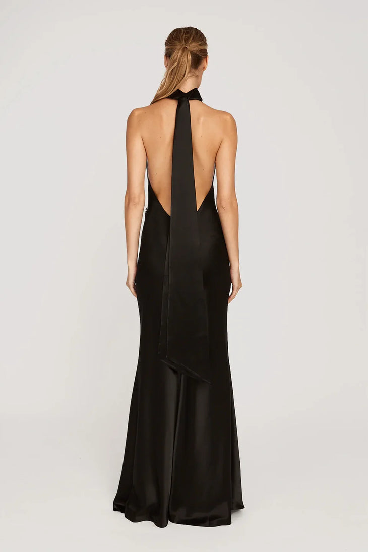 Woman wearing black halter satin gown with high slit and gold strappy heels — Sau Lee | Endless UAE