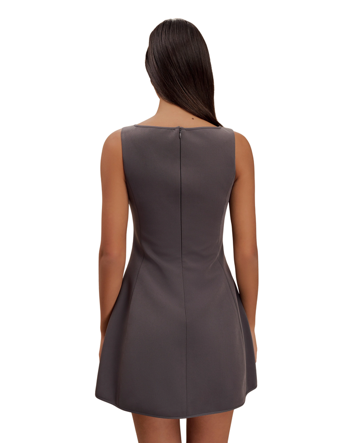 Woman wearing charcoal sleeveless suiting mini dress with front pockets and black platform heels — Meshki | Endless UAE