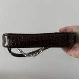 Dark brown croc-embossed mini shoulder bag with chain detail held in hand — By Far | Endless UAE