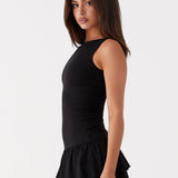 Black sleeveless mini dress with ruched waist and tiered frill skirt — Peppermayo | Endless UAE
