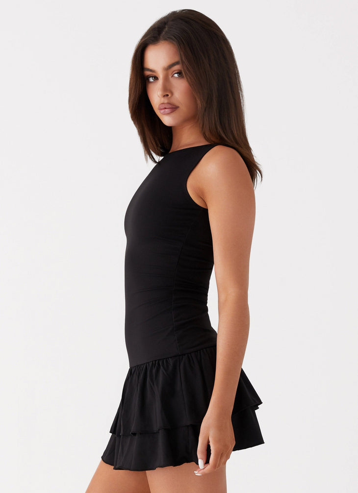 Black sleeveless mini dress with ruched waist and tiered frill skirt — Peppermayo | Endless UAE