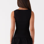 Black sleeveless mini dress with ruched waist and tiered frill skirt — Peppermayo | Endless UAE