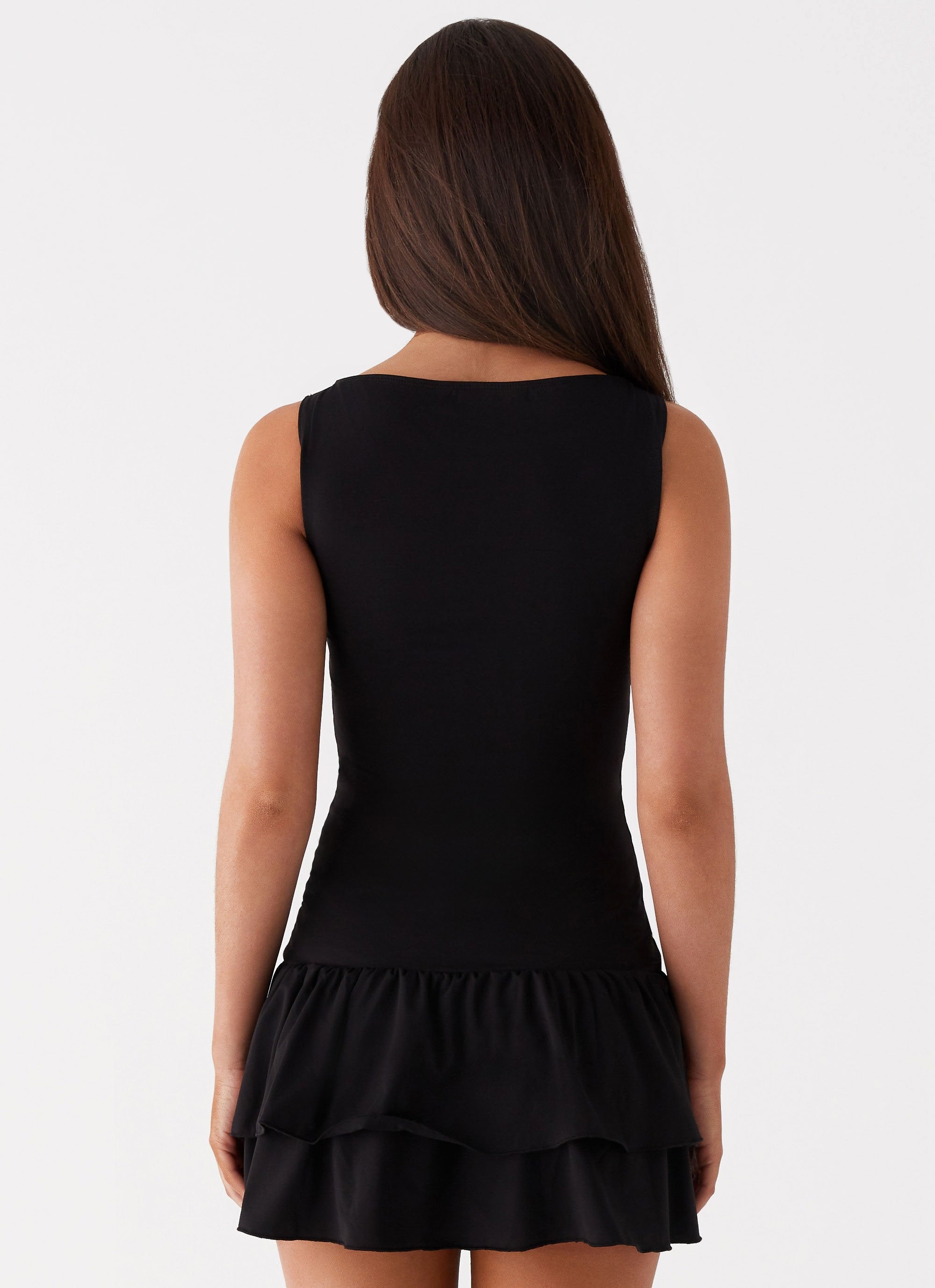 Black sleeveless mini dress with ruched waist and tiered frill skirt — Peppermayo | Endless UAE