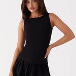 Black sleeveless mini dress with ruched waist and tiered frill skirt — Peppermayo | Endless UAE