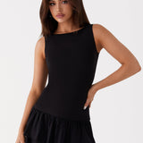 Black sleeveless mini dress with ruched waist and tiered frill skirt — Peppermayo | Endless UAE