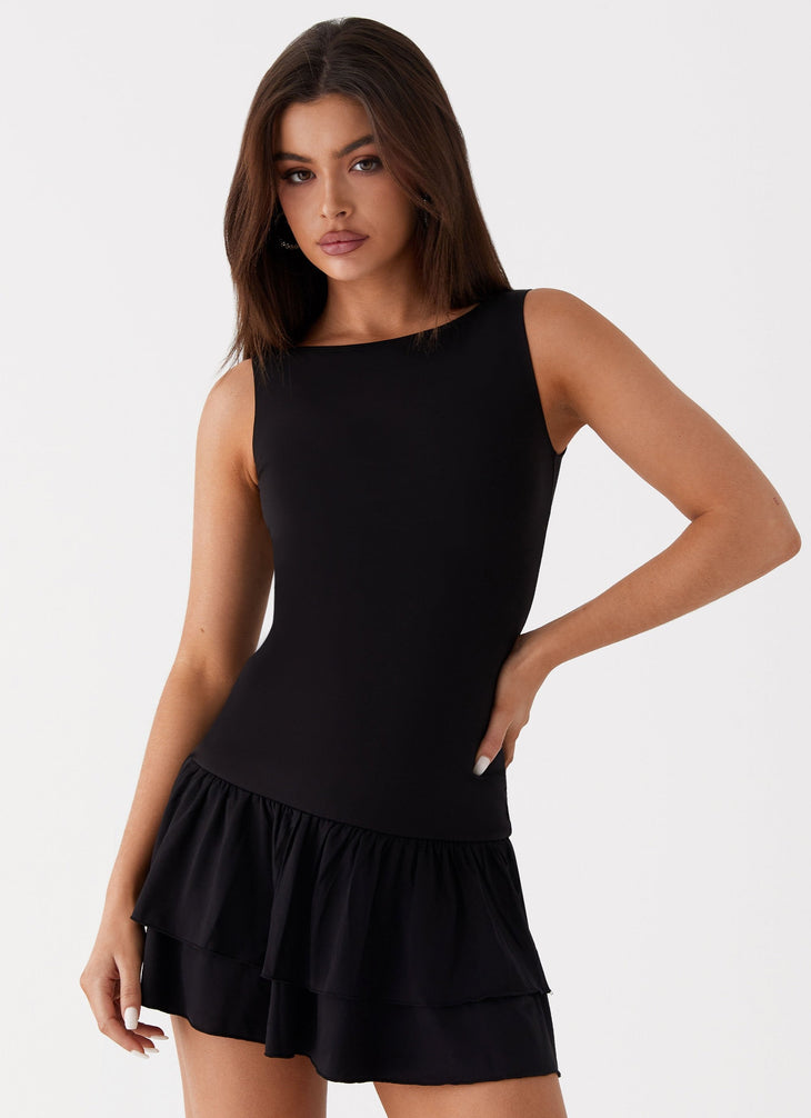 Black sleeveless mini dress with ruched waist and tiered frill skirt — Peppermayo | Endless UAE