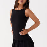 Black sleeveless mini dress with ruched waist and tiered frill skirt — Peppermayo | Endless UAE