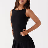 Black sleeveless mini dress with ruched waist and tiered frill skirt — Peppermayo | Endless UAE