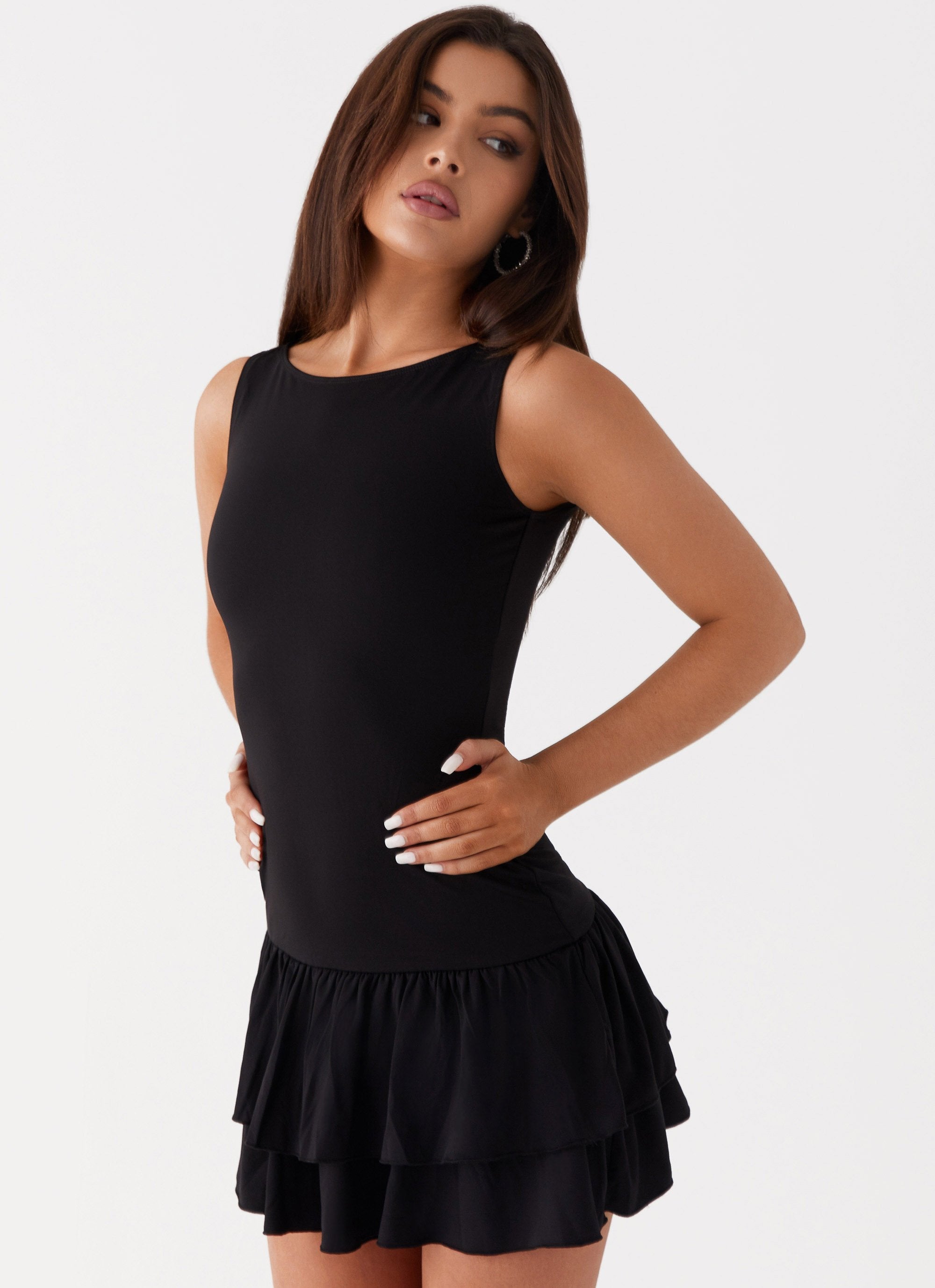Black sleeveless mini dress with ruched waist and tiered frill skirt — Peppermayo | Endless UAE