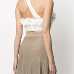 White one-shoulder crop top with ruffled floral trim and asymmetric strap detail paired with gold pleated skirt — Zimmermann | Endless UAE