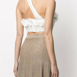 White one-shoulder crop top with ruffled floral trim and asymmetric strap detail paired with gold pleated skirt — Zimmermann | Endless UAE
