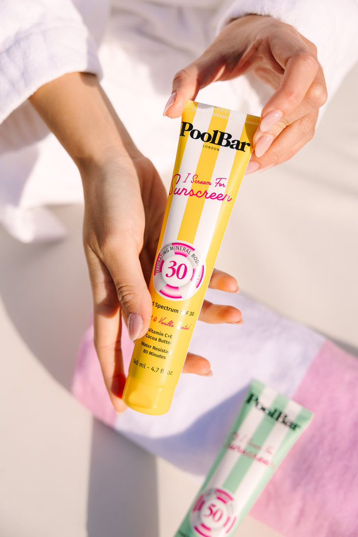 Yellow tube of PoolBar London SPF 30 mineral sunscreen with pink circular badge and striped design — PoolBar London | Endless UAE