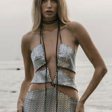 Silver sequined cut-out mini dress with halter neck tie and bodycon fit on beach — Formidable by Mina | Endless UAE