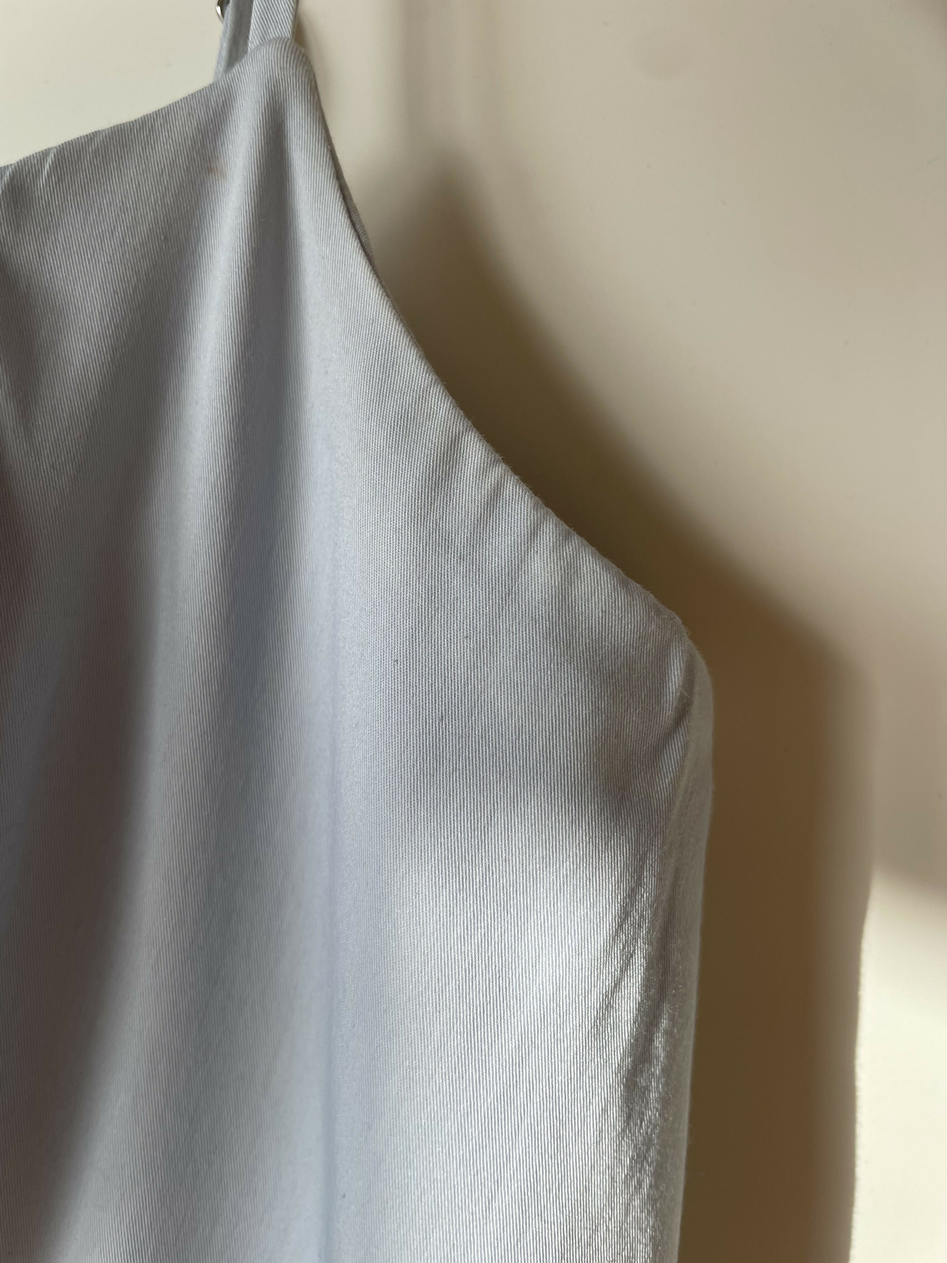 Woman wearing light blue sleeveless midi dress with corset top and full skirt — Endless | Endless UAE