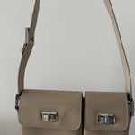Beige patent leather shoulder bag with dual compartments and silver turnlock closures — Endless | Endless UAE