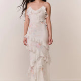 Woman modeling a cream floral ruffled maxi dress with delicate pastel details — LoveShackFancy | Endless UAE