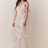 Woman modeling a cream floral ruffled maxi dress with delicate pastel details — LoveShackFancy | Endless UAE