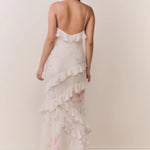 Woman modeling a cream floral ruffled maxi dress with delicate pastel details — LoveShackFancy | Endless UAE