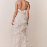 Woman modeling a cream floral ruffled maxi dress with delicate pastel details — LoveShackFancy | Endless UAE