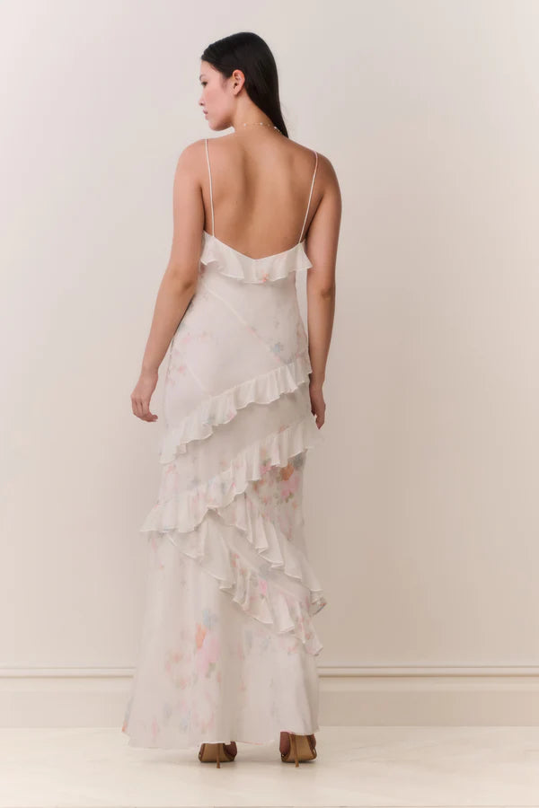 Woman modeling a cream floral ruffled maxi dress with delicate pastel details — LoveShackFancy | Endless UAE
