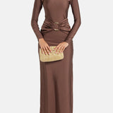 Woman wearing brown long-sleeve maxi dress with ruched waist belt and gold clutch — Lediel | Endless UAE