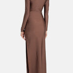 Woman wearing brown long-sleeve maxi dress with ruched waist belt and gold clutch — Lediel | Endless UAE