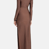 Woman wearing brown long-sleeve maxi dress with ruched waist belt and gold clutch — Lediel | Endless UAE