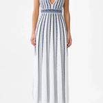 Woman wearing striped halter neck sleeveless knit maxi dress with navy and white vertical stripes — Camilla | Endless UAE
