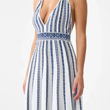 Woman wearing striped halter neck sleeveless knit maxi dress with navy and white vertical stripes — Camilla | Endless UAE