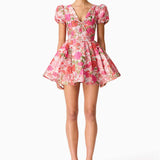 Woman wearing pink floral mini dress with short puffed sleeves and tie-front neckline — Elliatt | Endless UAE