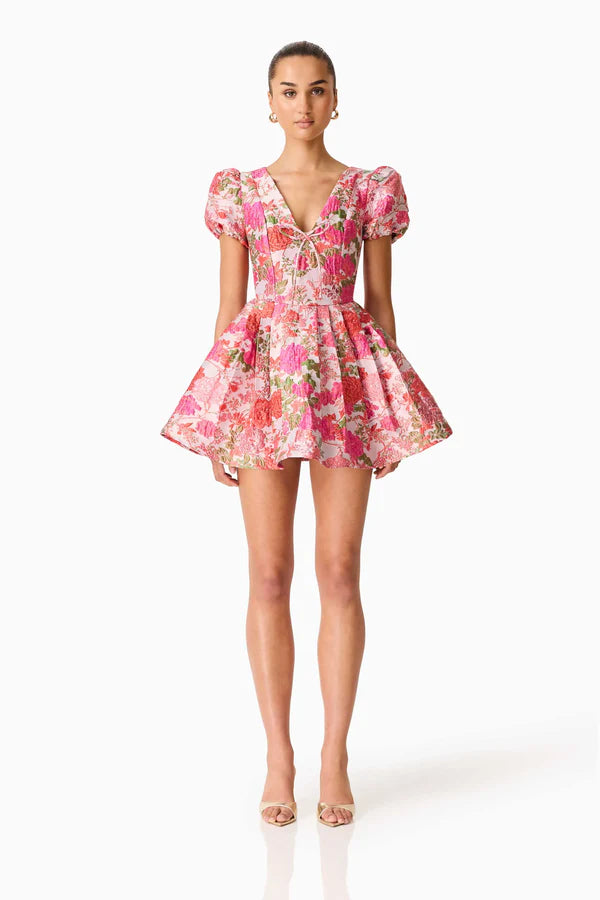 Woman wearing pink floral mini dress with short puffed sleeves and tie-front neckline — Elliatt | Endless UAE