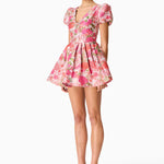 Woman wearing pink floral mini dress with short puffed sleeves and tie-front neckline — Elliatt | Endless UAE