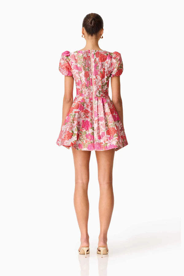 Woman wearing pink floral mini dress with short puffed sleeves and tie-front neckline — Elliatt | Endless UAE