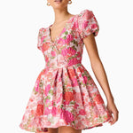 Woman wearing pink floral mini dress with short puffed sleeves and tie-front neckline — Elliatt | Endless UAE