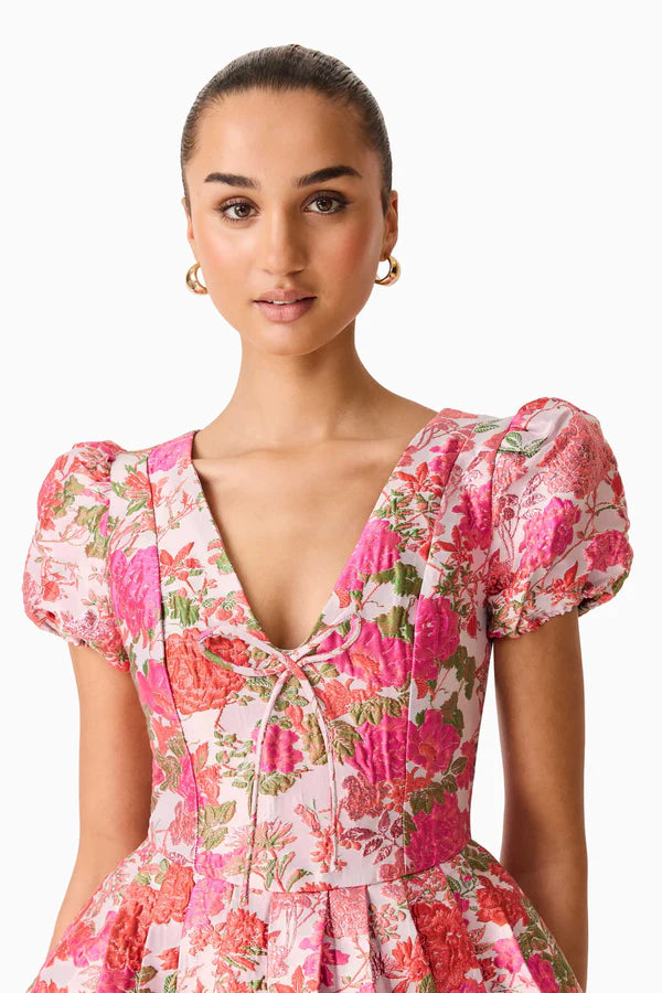 Woman wearing pink floral mini dress with short puffed sleeves and tie-front neckline — Elliatt | Endless UAE