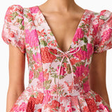 Woman wearing pink floral mini dress with short puffed sleeves and tie-front neckline — Elliatt | Endless UAE