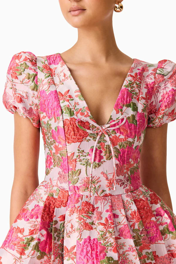 Woman wearing pink floral mini dress with short puffed sleeves and tie-front neckline — Elliatt | Endless UAE
