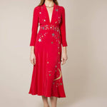 Woman wearing red midi wrap dress with gold and silver star embroidery, styled with white slip-on shoes — RIXO | Endless UAE