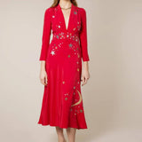 Woman wearing red midi wrap dress with gold and silver star embroidery, styled with white slip-on shoes — RIXO | Endless UAE