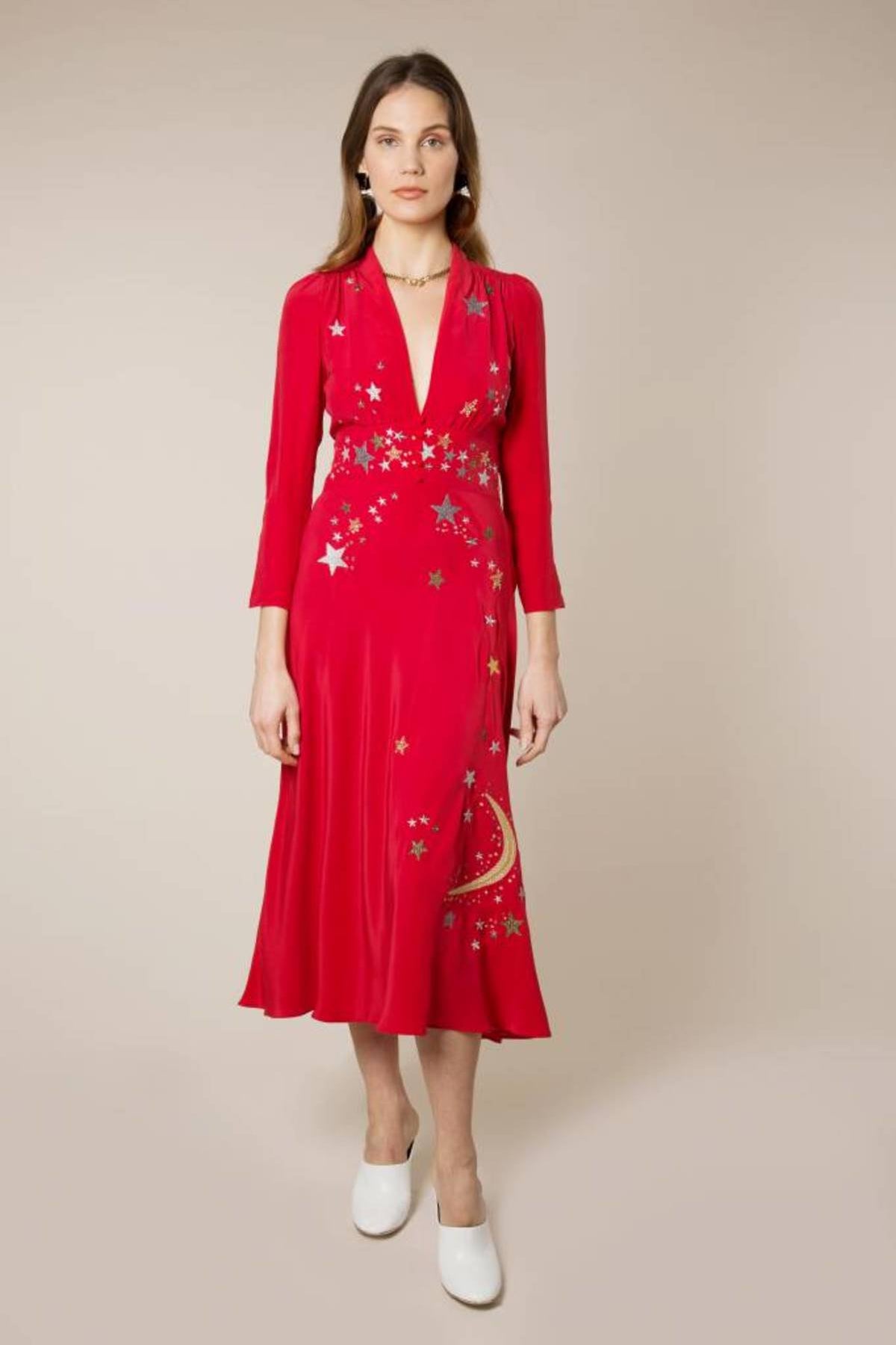 Woman wearing red midi wrap dress with gold and silver star embroidery, styled with white slip-on shoes — RIXO | Endless UAE