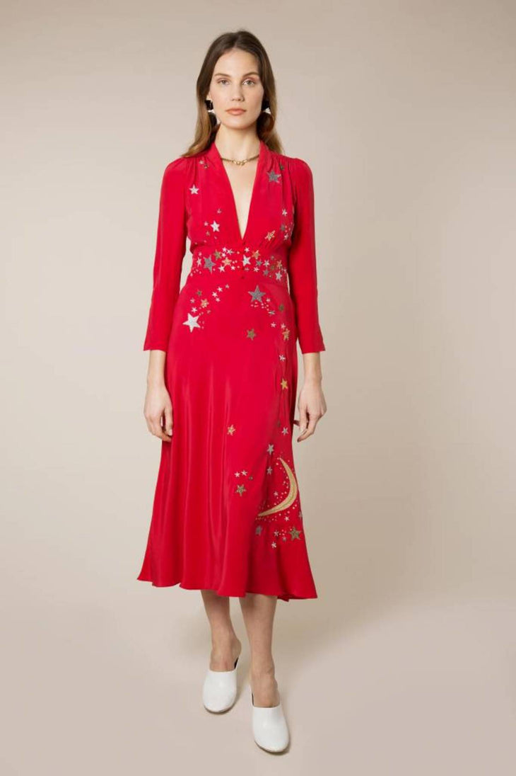 Woman wearing red midi wrap dress with gold and silver star embroidery, styled with white slip-on shoes — RIXO | Endless UAE