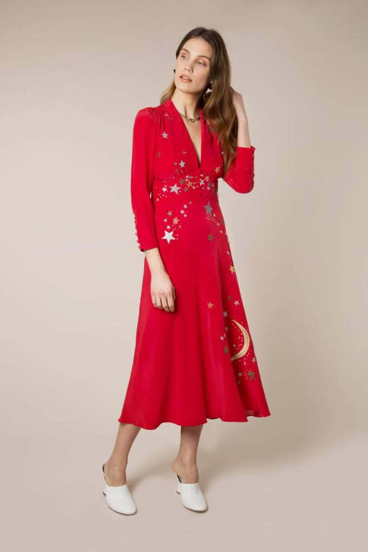 Woman wearing red midi wrap dress with gold and silver star embroidery, styled with white slip-on shoes — RIXO | Endless UAE