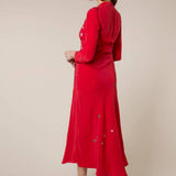 Woman wearing red midi wrap dress with gold and silver star embroidery, styled with white slip-on shoes — RIXO | Endless UAE