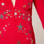 Woman wearing red midi wrap dress with gold and silver star embroidery, styled with white slip-on shoes — RIXO | Endless UAE