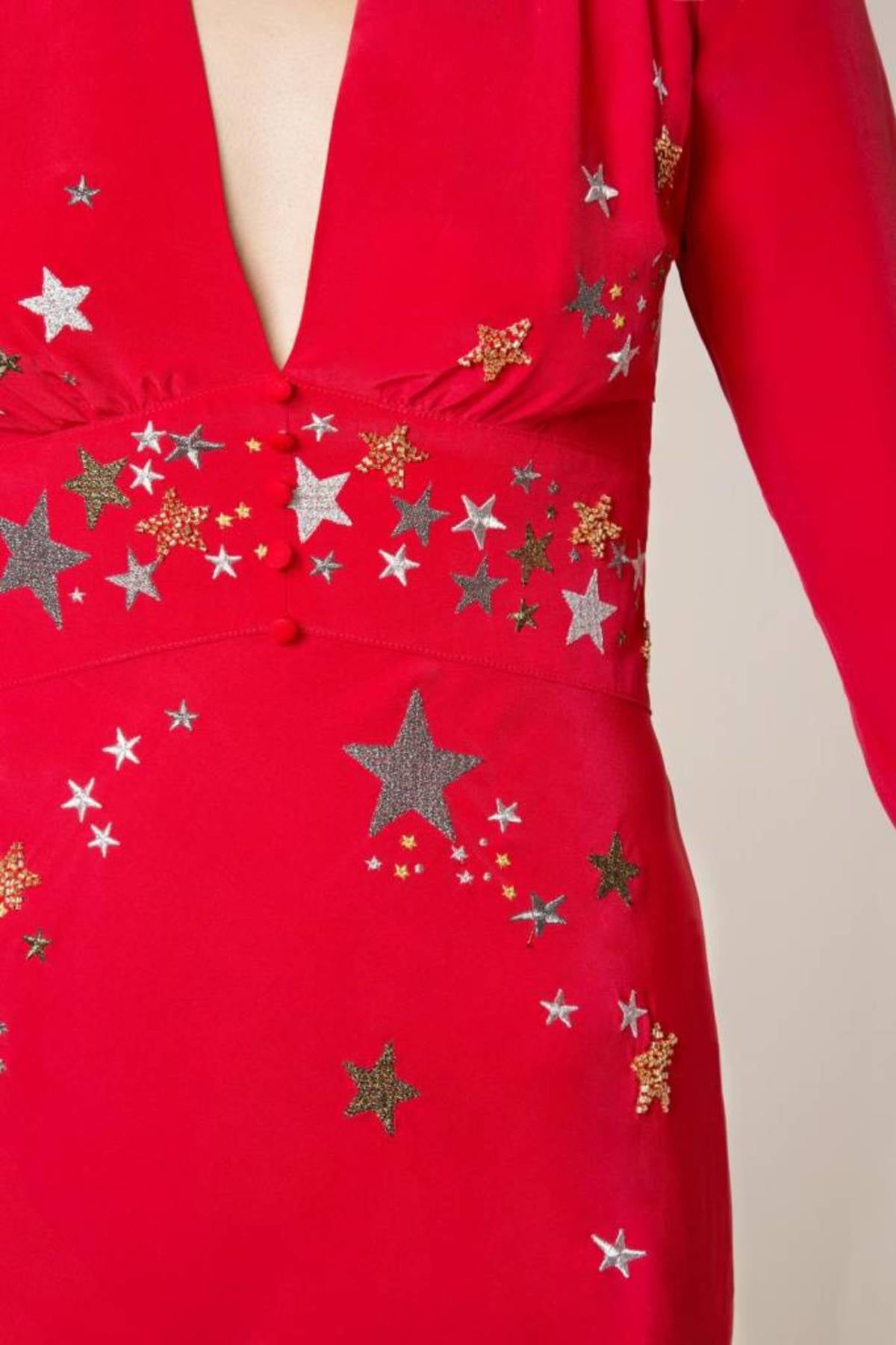 Woman wearing red midi wrap dress with gold and silver star embroidery, styled with white slip-on shoes — RIXO | Endless UAE