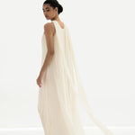 Elegant cream sleeveless maxi dress with flowing pleated cape back detail and floor-length silhouette — Nora The Label | Endless UAE