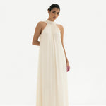 Elegant cream halter neck maxi dress with flowing silhouette and gathered neckline detail — Nora The Label | Endless UAE