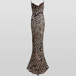 Woman wearing black and cream zebra stripe maxi dress with cowl neckline — Endless | Endless UAE