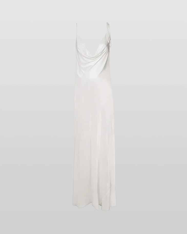 Woman wearing white cowl neck sleeveless maxi dress against textured beige wall — Rat & Boa | Endless UAE