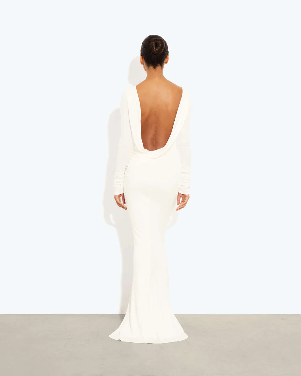 Woman wearing a cream long-sleeved fitted maxi dress with a crew neckline — Rat & Boa | Endless UAE